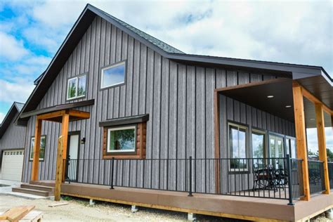 dark grey house with metal roof|gray siding black windows.